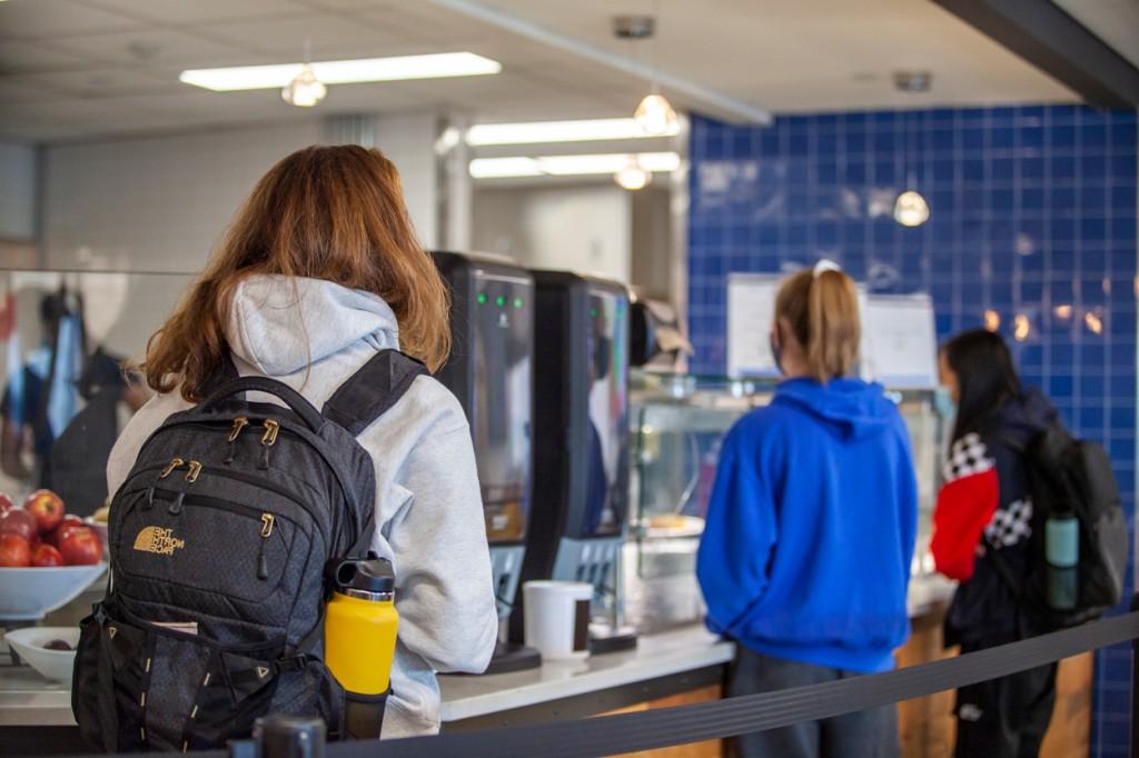 Students lining up to pay at a food counter in the Commons